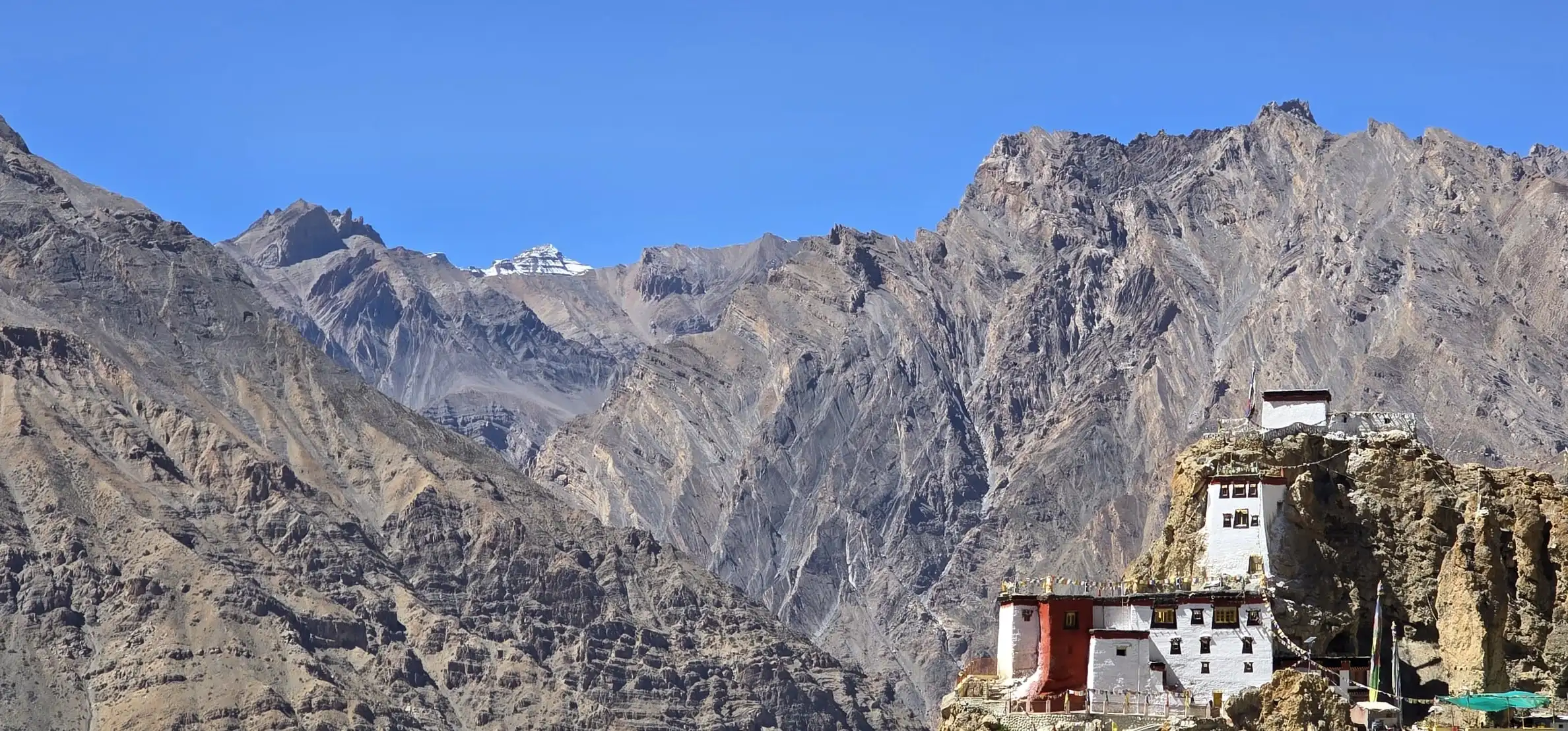 Dhankar Monastery on a rocky spur above the Spiti valley, with folded grey mountains behind