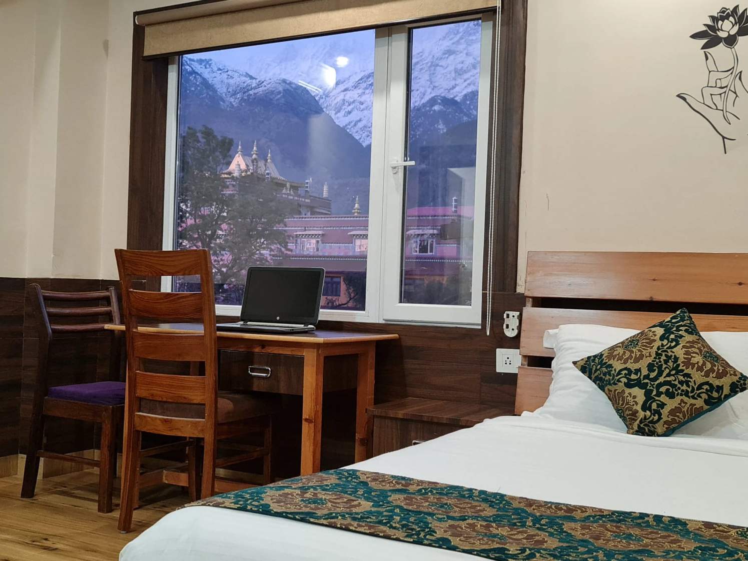 A monastery roof and the snow-capped Dhauladhar, seen from a window near Norbulingka